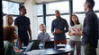 © Monkey Business - Multi-Cultural Business Team Meeting And Collaborating Around Table In Modern Office Together