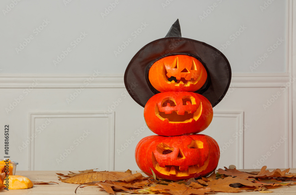 Trio of jack-o-lanterns stacked, showcasing Halloween carvings Stock ...