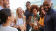 © Monkey Business - Multi-Cultural Business Team Meeting Outdoors For After Work Drinks On Office Rooftop Or Bar