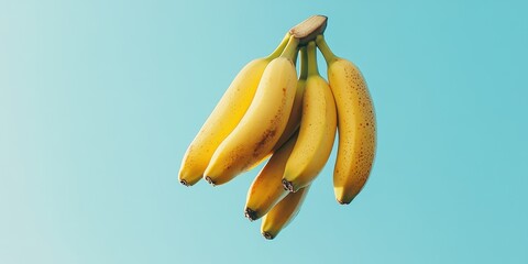 A vibrant bunch of ripe bananas against a soft blue background, perfect for food-related themes and healthy lifestyle imagery.