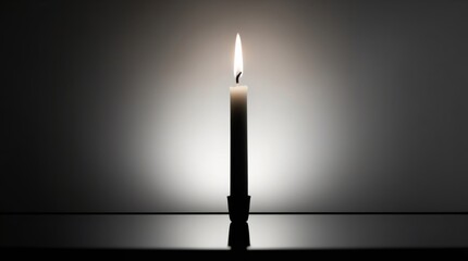 A serene black and white photograph of a singular, slender, white candle standing upright on a dark