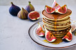 © maxximmm - Plate of food with pancakes, figs, honey and other foods. sweet breakfast pancake concept. a stack of pancakes with figs, honey, and a shaved egg. a stack of food with figs, honey, and a sprig of.