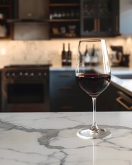 Elegant Wine Glass on Marble Countertop with Busy Kitchen Background