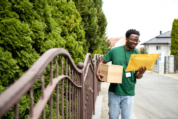 Poster - Postal service and shipping business. Happy courier delivering mail to the address.