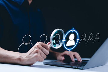Wall Mural - target customer concept. crm, customer relationship management, a person using a laptop with magnify