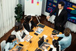© InfiniteFlow - Wide top view of diverse group of business analyst team analyzing financial data report paper on meeting table. Chart and graph dashboard by business intelligence analysis. Meticulous