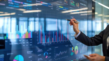 Fototapete - A business professional analyzing data on a digital display with colorful graphs and charts in a modern office environment.