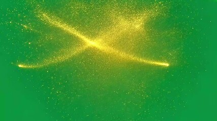 Poster - Golden particles are exploding and dispersing on a green screen background.