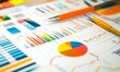 © jambulart - Colorful charts, graphs, and pens on a white table.