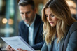 © JJ1990 - Woman reviewing documents with a colleague.