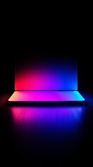 Poster - A laptop with a colorful screen is lit up in a dark room