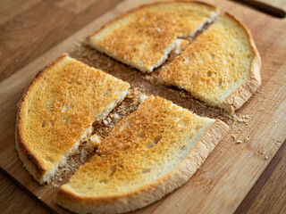 Tasty toasted bread for bruschetta on wooden table
