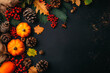 © JM_GUERRERO - A black background with a variety of fall foliage including red berries