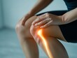 © Tadeusz - Female athlete experiencing knee pain with glowing medical graphic effect.