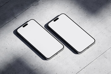 Wall Mural - Two phones with a blank screen on a concrete background