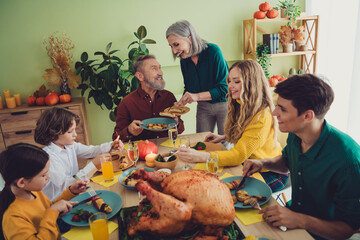 Poster - Photo of charming happy big family celebrating thanksgiving day cosy atmosphere sitting eating turkey indoors room home