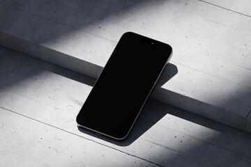 Wall Mural - Phone with a blank screen on a concrete background