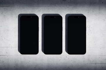 Wall Mural - Three phones with a blank screen on a concrete background