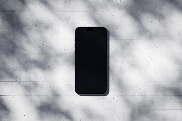 Wall Mural - Phone with a blank screen on a concrete background