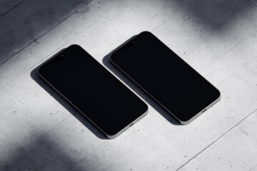 Wall Mural - Two phones with a blank screen on a concrete background