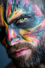 Wall Mural -  A tight shot of a man with a multicolored, painted face gazing intently into the camera