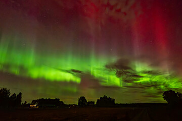 Wall Mural - northern lights dancing over country landscape in noreth of sweden.