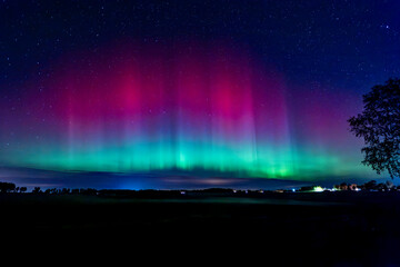 Wall Mural - northern lights dancing over country landscape in noreth of sweden.