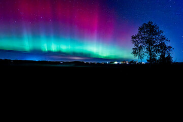 Wall Mural - northern lights dancing over country landscape in noreth of sweden.