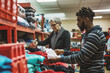 © Bonsales - Volunteers sorting clothes in donation center, teamwork in action, helping community in need, charity work, social responsibility concept