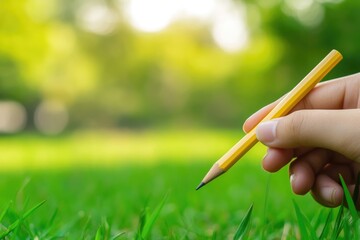 Aufkleber - A person holding a pencil in their hand, ready to create