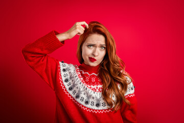 Canvas Print - Portrait of stressed redhair upset beautiful girl forgot her keys scratching head guilty in trouble isolated on red color background