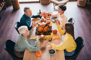 Wall Mural - Above view portrait of big friendly family hold hands pray table celebrate thanksgiving day dinner flat indoors