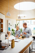 © Melissa Milis Photography/Stocksy - Two children and dad cooking