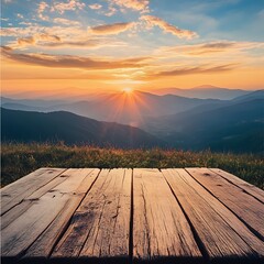 A scenic sunset view over mountains with a wooden platform in the foreground.