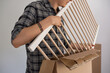 © Milles Studio/Stocksy - Man unpacking furniture
