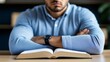 © fotogurme - Office worker reviewing an anti-bullying policy handbook at their desk, preparing to report a workplace bully, policy theme