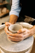 © Artem Podrez/Stocksy - Close-up Hands Molding Clay on Spinning Wheel