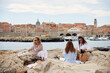 © Boris Jovanovic/Stocksy - Women enjoy on a beach picnic near Dubrovnik
