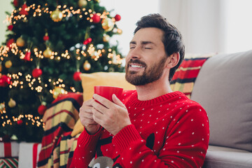 Canvas Print - Photo of nice young man closed eyes smell cacao ugly sweater christmas time apartment indoors