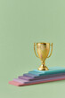 © Yaroslav Danylchenko/Stocksy - Golden winner goblet standing on multilayered platform