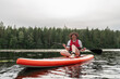© Basil Pind/Stocksy - Woman Paddleboarding on a Calm Lake