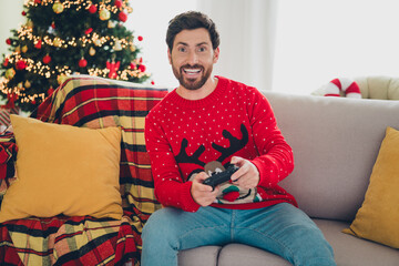 Poster - Portrait of nice young man play videogames christmas holiday time flat indoors