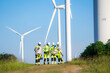© FotoArtist - Electric engineer wearing Personal protective equipment working at wind turbines farm .  Wind turbine technicians doing wind turbine blade inspection with drone.