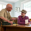 © Raymond Forbes LLC/Stocksy - Senior Veteran happy Great Grandfather  Looking historic photos home