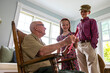 © Raymond Forbes LLC/Stocksy - Young Girl hands card portrait thanking veteran tribute with brother
