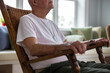 © Raymond Forbes LLC/Stocksy - Military man Veteran at home in rocking chair