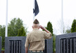 © Raymond Forbes LLC/Stocksy - Senior Citizen military man at war memorial rear view