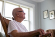 © Raymond Forbes LLC/Stocksy - Senior military man Veteran at home in rocking chair