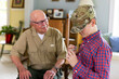 © Raymond Forbes LLC/Stocksy - Veteran family Great Grandfather  Grandson give dog tag