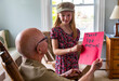 © Raymond Forbes LLC/Stocksy - Young Girl smile gives card portrait thanking veteran tribute